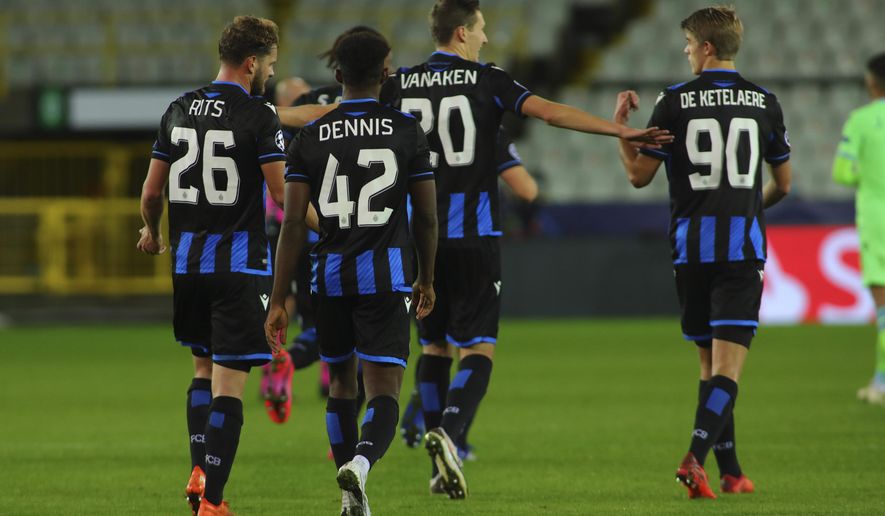 Brugge's Hans Vanaken, center, celebrates with teammates after scoring his side's first goal during the Champions League Group F soccer match between Brugge and Lazio at the Jan Breydel stadium in Bruges, Belgium, Wednesday, Oct. 28, 2020. Vanaken scored an equaliser goal and the match ended in a 1-1 draw. (AP Photo/ Olivier Matthys)
