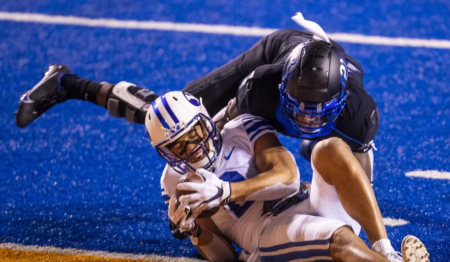 BYU wide receiver Neil Pau'u pushes across the goal line defended by Boise State safety Tyreque Jones (21) to score for the Cougars in the third quarter Friday, Nov. 6, 2020 at Albertsons Stadium in Boise. (Darin Oswald/Idaho Statesman via AP)