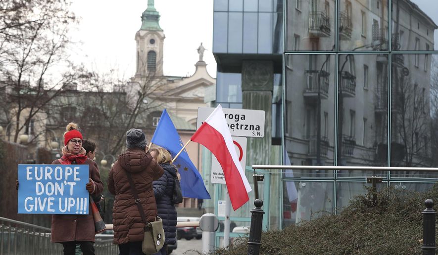 FILE - In this Jan. 28, 2020, file photo, demonstrators protest against Poland&#39;s government&#39;s efforts to control the court system in front of the Supreme Court in Warsaw, Poland. The European Union still hasn&#39;t completely sorted out its messy post-divorce relationship with Britain — but it has already been plunged into another major crisis. This time the 27-member union is being tested as Poland and Hungary block passage of its budget for the next seven years and an ambitious package aimed at rescuing economies ravaged by the coronavirus pandemic. (AP Photo/Czarek Sokolowski, File)