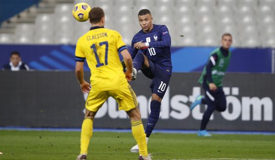 France&#x27;s Kylian Mbappe passes the ball over Sweden&#x27;s Viktor Claesson during the UEFA Nations League soccer match between France and Sweden at the Stade de France stadium in Saint-Denis, northern Paris, Tuesday, Nov. 17, 2020. (AP Photo/Francois Mori)
