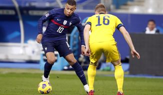 France&#x27;s Kylian Mbappe, left, controls the ball as Sweden&#x27;s Emil Krafth defends during the UEFA Nations League soccer match between France and Sweden at the Stade de France stadium in Saint-Denis, northern Paris, Tuesday, Nov. 17, 2020. (AP Photo/Francois Mori)