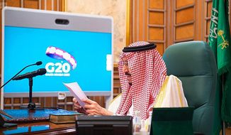 FILE - In this March 26, 2020, file photo released by Saudi Press Agency, SPA, Saudi King Salman, chairs a video call of world leaders from the Group of 20 and other international bodies and organizations, from his office in Riyadh, Saudi Arabia. The Nov. 21-22, 2020, Group of 20 summit, hosted by Saudi Arabia, will be held online this year because of the coronavirus. The pandemic has offered the G-20 an opportunity to prove how such bodies can facilitate international cooperation in crises — but has also underscored their shortcomings. (Saudi Press Agency via AP, File)
