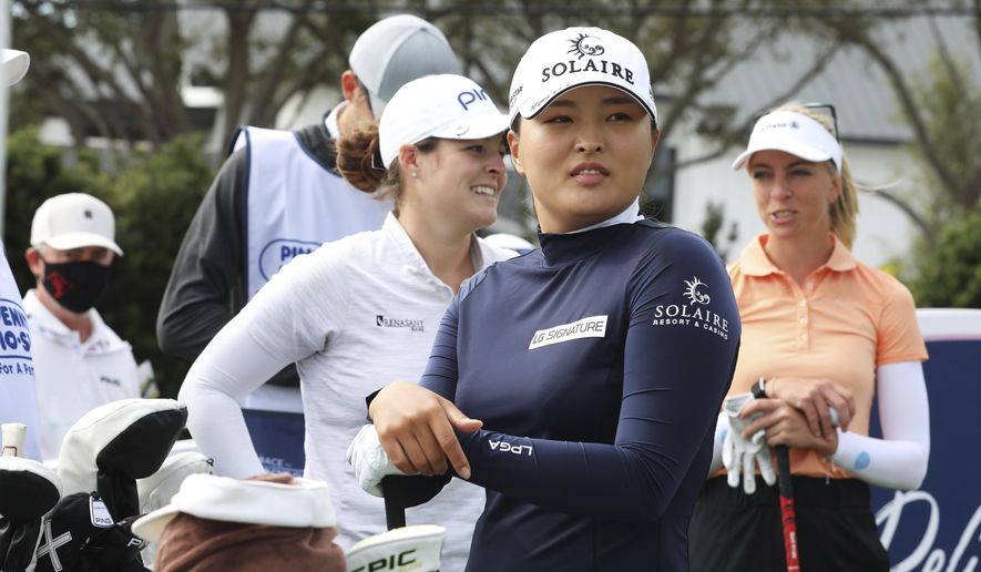 Jin Young Ko, center, waits to tee off on the first hole during the first round of the LPGA Pelican Women's Championship golf tournament at Pelican Golf Club, Thursday, Nov. 19 2020, Belleair, Fla. (Scott Keeler/Tampa Bay Times via AP)