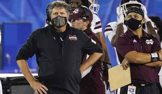 FILE- In this Saturday, Oct. 10, 2020, file photo, Mississippi State coach Mike Leach stands on the sideline during the second half of the team&#39;s NCAA college football game against Kentucky in Lexington, Ky. Mississippi State has managed a single victory, over winless Vanderbilt, in its last five games, averaging a mere 7.5 points in the losses. They face Georgia on Saturday night in Athens, Ga. (AP Photo/Bryan Woolston, File)