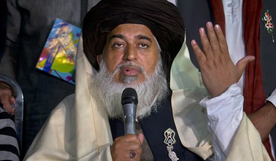 FILE - In this Nov. 26, 2017 file photo, Khadim Hussein Rizvi, head of &#39;Tehreek-e-Labaik Pakistan, a religious political party, speaks during a press conference in Islamabad, Pakistan. Rizvi, a radical religious cleric, who led tens of thousands in anti-France around the country, died Thursday, Nov. 19, 2020. His spokesman and a doctor at the hospital where Rizvi died said he was suffering from COVID-like symptoms but was not tested for the virus. (AP Photo/Anjum Naveed, File)