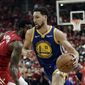 In this May 10, 2019, file photo, Golden State Warriors&#x27; Klay Thompson (11) drives past Houston Rockets&#x27; Iman Shumpert during the first half of Game 6 of a second-round NBA basketball playoff series in Houston. The Warriors said Thursday, Nov. 19, 2020, that Thompson has suffered a torn right Achilles tendon and is expected to miss the upcoming season.  Thompson was injured during a pickup game in Southern California the day before.  (AP Photo/Eric Gay, File) **FILE**