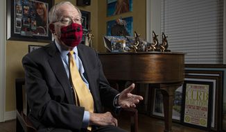 Sen. Lamar Alexander, R-Tenn., speaks from behind a face mask during an interview Friday, Nov. 20, 2020, in Nashville, Tenn. (AP Photo/Wade Payne)