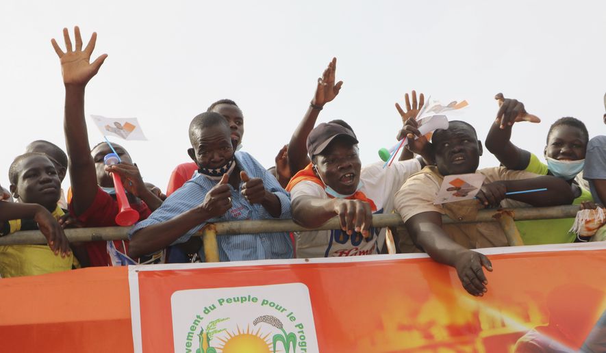 Supporters of Burkina Faso President Roch Kabore attend a campaign rally in Bobo-Dioulasso Thursday, Nov. 5, 2020. Burkina Faso will go to the polls on Nov. 22, 2020, to vote in presidential and legislative elections marred by ongoing violence. Attacks linked to Islamic militants have ravaged the once peaceful nation.(AP Photo/Sam Mednick)