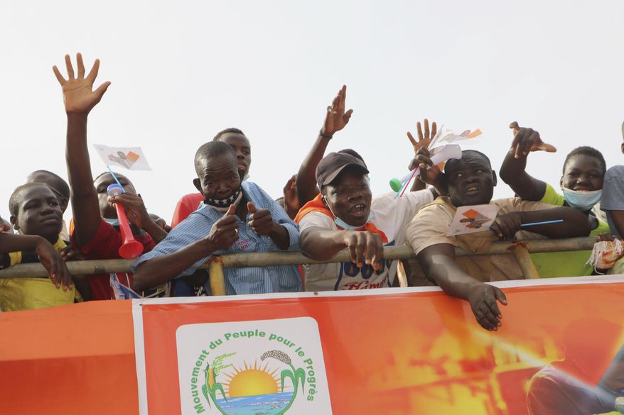 Supporters of Burkina Faso President Roch Kabore attend a campaign rally in Bobo-Dioulasso Thursday, Nov. 5, 2020. Burkina Faso will go to the polls on Nov. 22, 2020, to vote in presidential and legislative elections marred by ongoing violence. Attacks linked to Islamic militants have ravaged the once peaceful nation.(AP Photo/Sam Mednick)