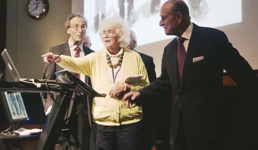 FILE - In this May 29, 2013 file photo, travel writer, journalist and author, Jan Morris, center, with the Duke of Edinburgh, right, during a reception to celebrate the 60th Anniversary of the ascent of Everest, at the Royal Geographical Society in London. Morris, the celebrated journalist, historian, world traveler and fiction writer who became a pioneer of the transgender movement, has died at 94. Her literary representative, United Agents, says Morris died in Wales on Friday, Nov. 20, 2020. (Yui Mok/PA via AP, file)