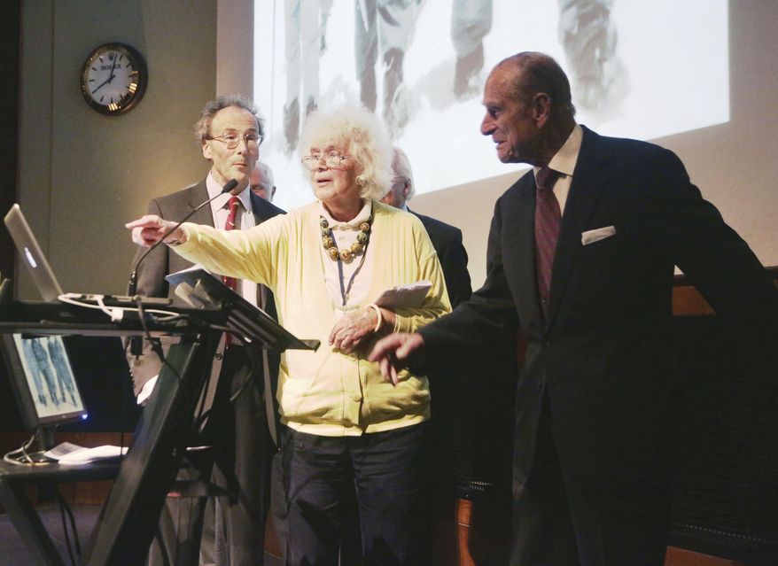 FILE - In this May 29, 2013 file photo, travel writer, journalist and author, Jan Morris, center, with the Duke of Edinburgh, right, during a reception to celebrate the 60th Anniversary of the ascent of Everest, at the Royal Geographical Society in London. Morris, the celebrated journalist, historian, world traveler and fiction writer who became a pioneer of the transgender movement, has died at 94. Her literary representative, United Agents, says Morris died in Wales on Friday, Nov. 20, 2020. (Yui Mok/PA via AP, file)