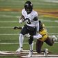 Purdue wide receiver David Bell (3) tries to get away from Minnesota defensive back Justus Harris (21) during the first half of an NCAA college football game Friday, Nov. 20, 2020, in Minneapolis. (AP Photo/Stacy Bengs)