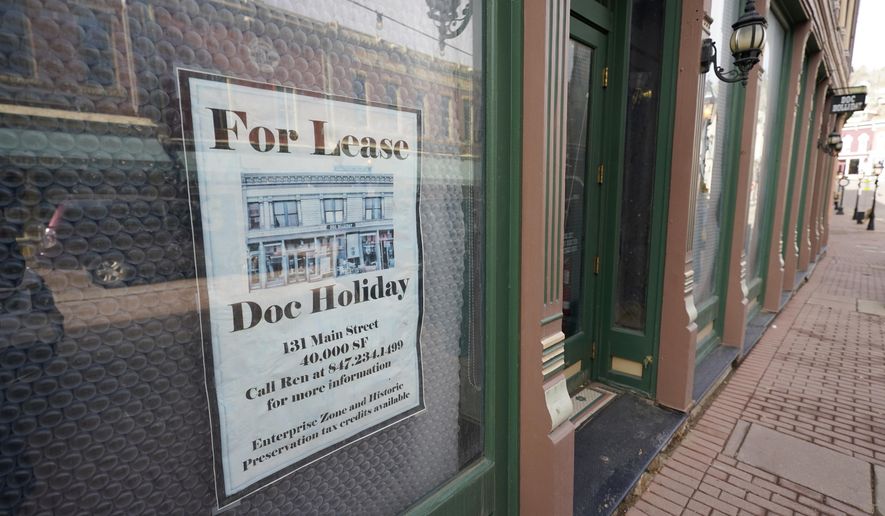 A lease sign hangs on the window of a shuttered casino along Main Street Wednesday, Nov. 18, 2020, in the gaming town of Central City, Colo. The building has been vacant for several years since the casino's closure. (AP Photo/David Zalubowski)