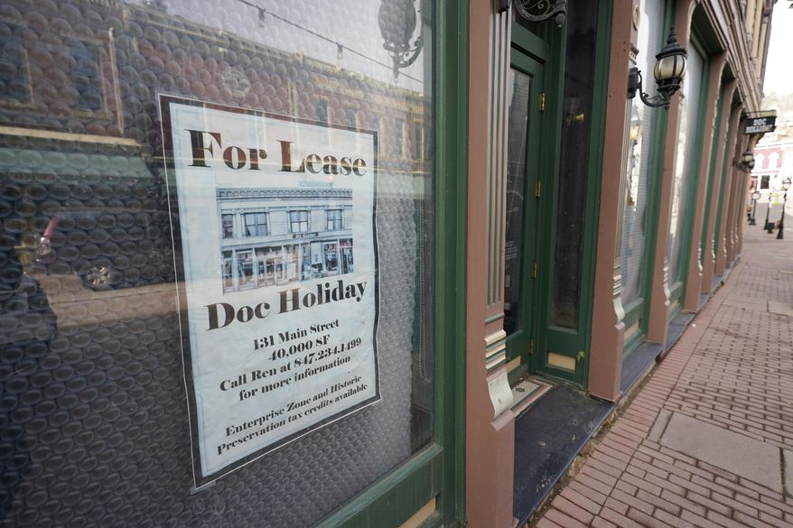 A lease sign hangs on the window of a shuttered casino along Main Street Wednesday, Nov. 18, 2020, in the gaming town of Central City, Colo. The building has been vacant for several years since the casino's closure. (AP Photo/David Zalubowski)