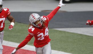 Ohio State defensive back Shaun Wade celebrates his interception and touchdown against Indiana during the second half of an NCAA college football game Saturday, Nov. 21, 2020, in Columbus, Ohio. Ohio State beat Indiana 42-35. (AP Photo/Jay LaPrete)