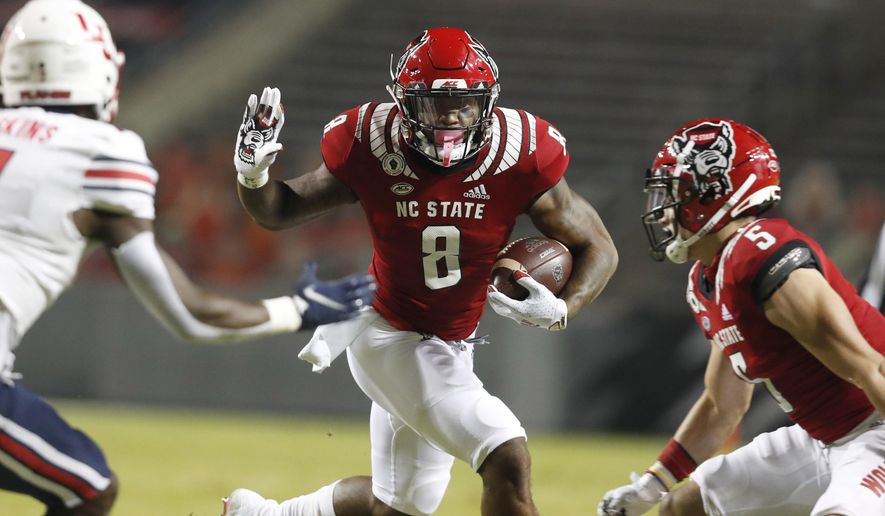 North Carolina State's Ricky Person Jr. (8) looks for running room against Liberty during the first half of an NCAA college football game Saturday, Nov. 21, 2020, in Raleigh, N.C. (Ethan Hyman/The News & Observer via AP, Pool)