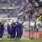 Orlando City players celebrate in front of fans after defeating New York City FC on penalty kicks in an MLS soccer playoff match, Saturday, Nov. 21, 2020, in Orlando, Fla. (AP Photo/Phelan M. Ebenhack)