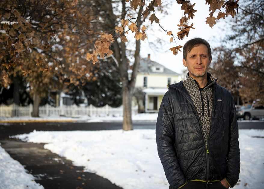 Mark Hebblewhite, a researcher at the University of Montana, is shown at his home on Thursday, Nov. 12, 2020 in Missoula, Mont. Hebblewhite and more than 150 fellow researchers from numerous nations compiled animal movement patterns over decades to chart the impacts of climate change on wildlife. (Ben Allan Smith/The Missoulian via AP)