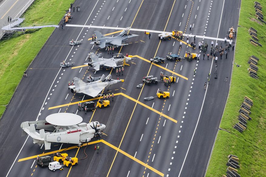 In this file photo released by Taiwan&#39;s Military News Agency, Taiwan war planes are parked on a highway during an exercise to simulate a response to a Chinese attack on its airfields in Changhua in southern Taiwan. (Military News Agency via AP) **FILE**