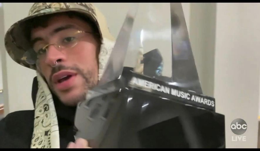 In this screen shot provided by ABC on Sunday, Nov. 22, 2020, Bad Bunny accepts the award for favorite latin album for “YHLQMDLG” at the American Music Awards at the Microsoft Theater in Los Angeles. (ABC via AP)