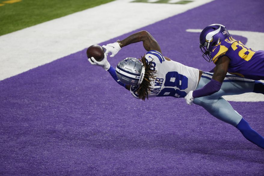 Dallas Cowboys wide receiver CeeDee Lamb (88) catches a 4-yard touchdown pass ahead of Minnesota Vikings cornerback Jeff Gladney, right, during the first half of an NFL football game, Sunday, Nov. 22, 2020, in Minneapolis. (AP Photo/Bruce Kluckhohn)