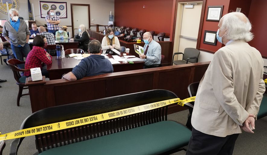An observer watches as Luzerne County workers canvas ballots. (AP Photo/Mary Altaffer, File)