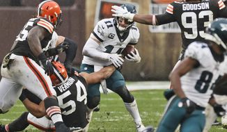 Philadelphia Eagles quarterback Carson Wentz (11) is sacked by Cleveland Browns defensive end Olivier Vernon (54) during the second half of an NFL football game, Sunday, Nov. 22, 2020, in Cleveland. (AP Photo/Ron Schwane)