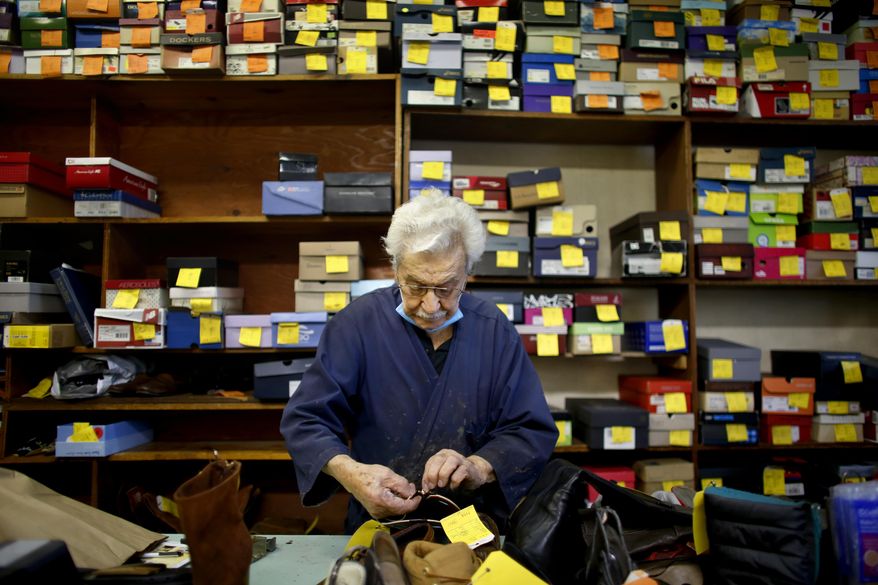 Alex Bredologos fixes the zipper on a boot Friday, Oct. 16, 2020 in Virginia Beach, Va. The cobbler, originally from Greece, has owned his shop at Hilltop in Virginia Beach for nearly 50 years. (Stephen M. Katz/The Virginian-Pilot via AP)