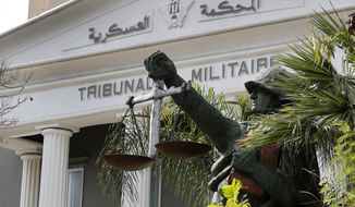 A statue of soldier carries balance, symbol of justice, is seen outside the military court in Beirut, Lebanon, Wednesday, May 27, 2020. A year after anti-government protests roiled Lebanon, dozens of protesters are being tried before military courts that human rights lawyers say grossly violate due process and fail to investigate allegations of torture and abuse. (AP Photo/Hussein Malla)