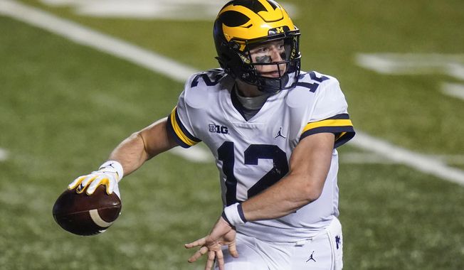 Michigan&#x27;s Cade McNamara throws a pass during the second half of an NCAA college football game against Rutgers on Saturday, Nov. 21, 2020, in Piscataway, N.J. Michigan won 48-42. (AP Photo/Frank Franklin II)