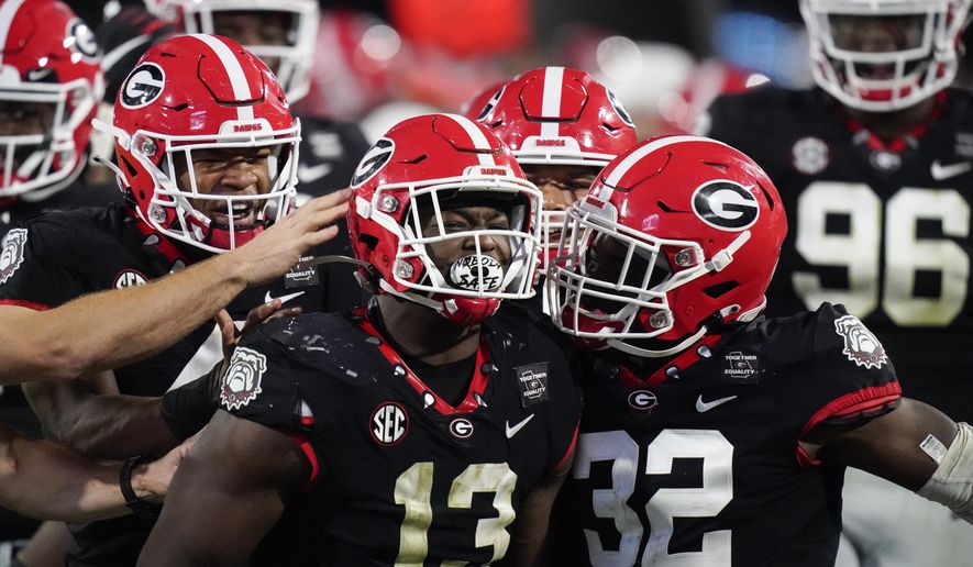 Georgia linebacker Azeez Ojulari (13) celebrates with teammates after a sack during the second half of the team&#39;s NCAA college football game against Mississippi State, Saturday, Nov. 21, 2020, in Athens, Ga. (AP Photo/Brynn Anderson)