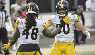 Pittsburgh Steelers linebacker Bud Dupree (48) and linebacker T.J. Watt, right, celebrate a big play against the Jacksonville Jaguars during the second half of an NFL football game, Sunday, Nov. 22, 2020, in Jacksonville, Fla. (AP Photo/Phelan M. Ebenhack)