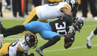 Jacksonville Jaguars running back James Robinson (30) is brought down by Pittsburgh Steelers linebacker Vince Williams, top, and safety Minkah Fitzpatrick (39) during the first half of an NFL football game, Sunday, Nov. 22, 2020, in Jacksonville, Fla. (AP Photo/Matt Stamey)
