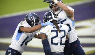 Tennessee Titans running back Derrick Henry (22) celebrates his game-winning touchdown with wide receiver Kalif Raymond, left, and tight end Anthony Firkser during overtime of an NFL football game against the Baltimore Ravens, Sunday, Nov. 22, 2020, in Baltimore. The Titans won 30-24 in overtime. (AP Photo/Nick Wass)