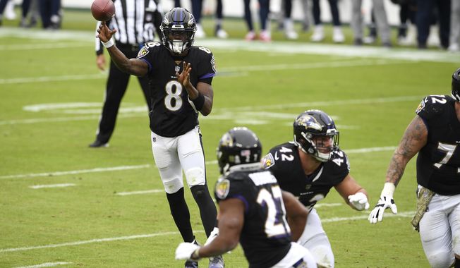 Baltimore Ravens quarterback Lamar Jackson (8) throws a pass to running back J.K. Dobbins (27) on a 2-point conversion play against the Tennessee Titans during the first half of an NFL football game, Sunday, Nov. 22, 2020, in Baltimore. (AP Photo/Nick Wass)