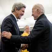 In this Feb. 1, 2020, file photo Democratic presidential candidate former Vice President Joe Biden smiles as former Secretary of State John Kerry, left, takes the podium to speak at a campaign stop at the South Slope Community Center in North Liberty, Iowa. (AP Photo/Andrew Harnik, File)