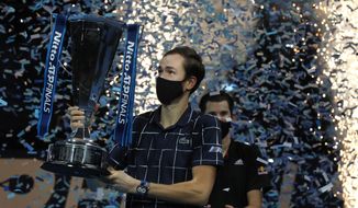 Daniil Medvedev of Russia holds up the winners trophy as confetti falls after defeating Dominic Thiem of Austria in the final of the ATP World Finals tennis match at the ATP World Finals tennis tournament at the O2 arena in London, Sunday, Nov. 22, 2020. (AP Photo/Frank Augstein)  **FILE**