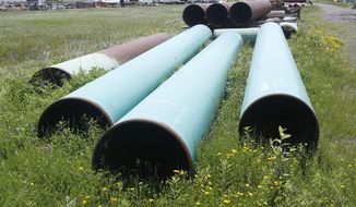 FILE - In this June 29, 2018, file photo, pipeline used to carry crude oil is shown at the Superior, Wis., terminal of Enbridge Energy. A significant permit has been granted to Enbridge&#39;s plan to replace its aging Line 3 oil pipeline across northern Minnesota. (AP Photo/Jim Mone, File)