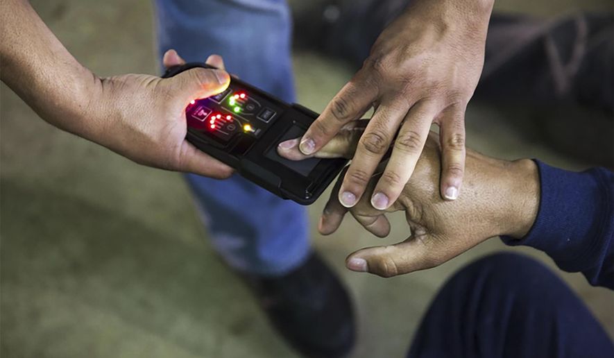 This undated photo obtained from Immigration and Customs Enforcement (ICE) shows a NeoScan 45 fingerprint scanner. The device, paired with an app known as EDDIE, is used by ICE to run remote ID checks. The app has been a core tool in President Donald Trump’s deportation crackdown, according to a new report based on a Freedom of Information Act lawsuit. (Immigration and Customs Enforcement via AP)
