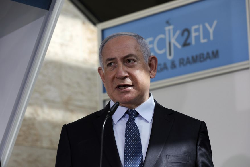 In this Nov. 9, 2020, file photo, Israeli Prime Minister Benjamin Netanyahu visits a new coronavirus lab at Ben-Gurion International Airport, near Tel Aviv, Israel. Israeli media reported Monday, Nov. 23, 2020, that Netanyahu flew to Saudi Arabia for a clandestine meeting with Crown Prince Mohammed bin Salman, which would mark the first known encounter between senior Israeli and Saudi officials. (Ohad Zwigenberg/Pool Photo via AP, File)  **FILE**