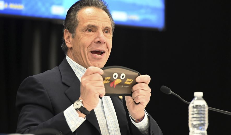 In this provided by the State of New York, New York Gov. Andrew Cuomo holds up a new Thanksgiving-themed face mask during his daily coronavirus briefing at the Wyandanch-Wheatley Heights Ambulance Corp. Headquarters in Wyandanch, N.Y. After disclosing that he will no longer be celebrating Thanksgiving with his 89-year-old mother in-person, Cuomo asked New Yorkers to abandon plans for in-person Thanksgiving festivities. (Kevin P. Coughlin/State of New York via AP)