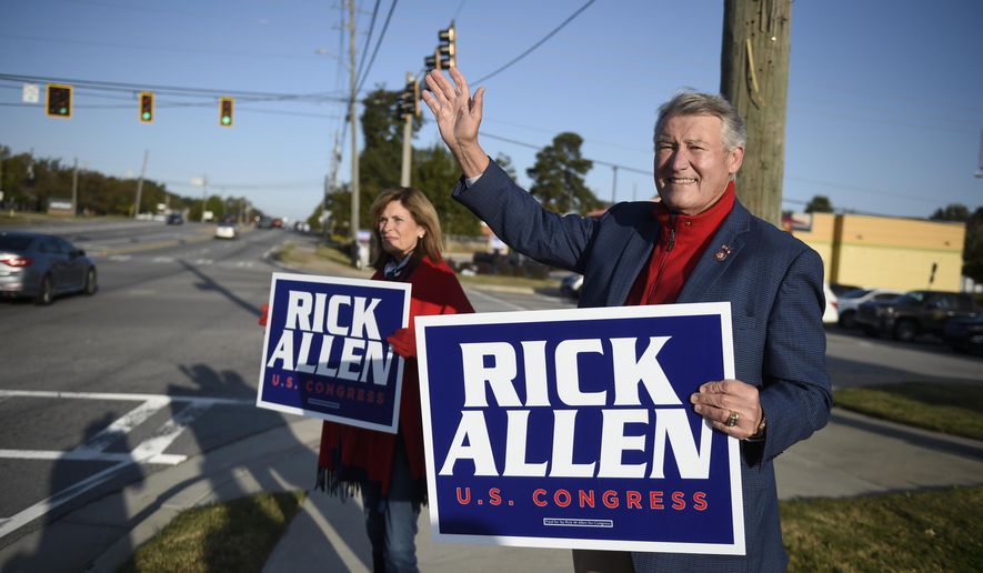 Congressman Rick Allen and his wife, Robin, campaign along Washington Road in Evans, Ga., on Election Day, Tuesday morning, Nov. 3, 2020. (Michael Holahan/The Augusta Chronicle via AP)
