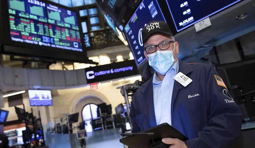 A trader works at the New York Stock Exchange, Tuesday, November 24, 2020. The Dow Jones Industrial Average traded above 30,000 points for the first time as investors were encouraged by the latest progress on developing coronavirus vaccines and news that the transition of power in the U.S. to President-elect Joe Biden will finally begin. (Nicole Pereira/NYSE via AP)