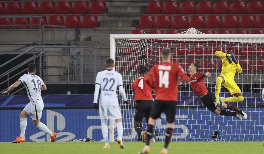 Chelsea's Olivier Giroud, left, scores his side's second goal during the Champions League, group E soccer match between Rennes and Chelsea at the Roazhon Park stadium in Rennes, France, Tuesday, Nov. 24, 2020. Chelsea won 2-1. (AP Photo/David Vincent)