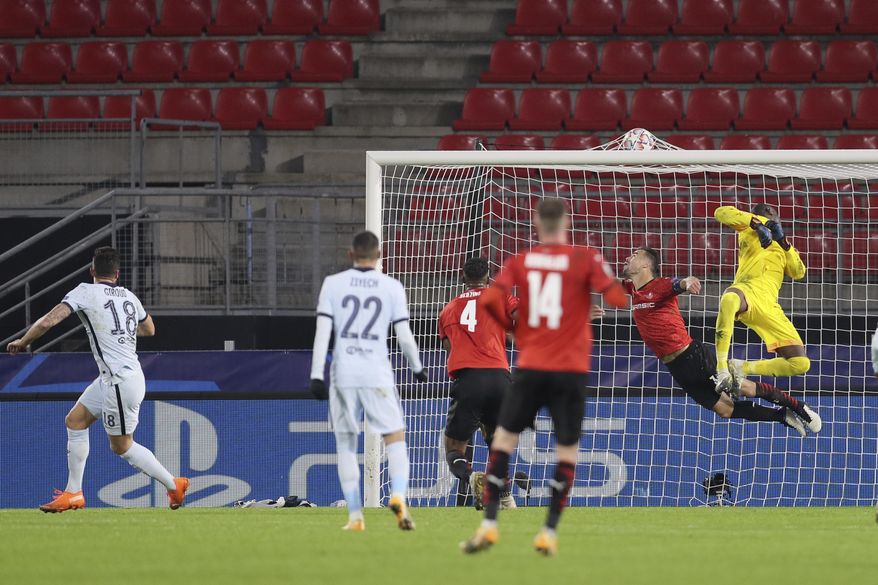 Chelsea's Olivier Giroud, left, scores his side's second goal during the Champions League, group E soccer match between Rennes and Chelsea at the Roazhon Park stadium in Rennes, France, Tuesday, Nov. 24, 2020. Chelsea won 2-1. (AP Photo/David Vincent)