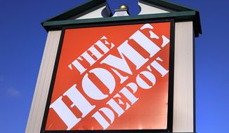 A Home Depot store sign is visible from Route 102, Wednesday, Nov. 18, 2020, in Londonderry, N.H.  Home Depot has reached a $17.5 million settlement with the attorney generals of most U.S. states over a 2014 data breach in which the payment card information of some 40 million customers was exposed. The Massachusetts Attorney General’s office detailed the settlement in a statement Tuesday, Nov. 24.  (AP Photo/Charles Krupa)