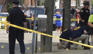 FILE - In this Monday Aug. 21, 2017 file photo shows evidence markers being placed on N. Court Street and the sidewalk next to the Jefferson County Courthouse in Steubenville, Ohio, after Jefferson County Judge Joseph Bruzzese Jr. was ambushed and shot earlier in the day. The Ohio Supreme Court has ruled that security camera footage of the judge being shot and wounded is a public record. The court&#39;s Tuesday, Nov. 24, 2020 ruling sided with arguments by The Associated Press in seeking access to the video. (Darrell Sapp/Pittsburgh Post-Gazette via AP)