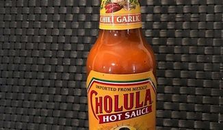 This Tuesday Nov. 24, 2020 photo shows a bottle of Cholula Hot Sauce. Spice maker McCormick &amp;amp; Co. is buying the parent of Cholula Hot Sauce from private-equity firm L Catteron for $800 million, expanding its reach in the hot sauce category.  That deal included French’s mustard and Frank’s RedHot brands. The company views the addition of Cholula as a way to appeal to millennials, a group that has a particular liking for the hot sauce.  (AP Photo/Charles Sheehan)