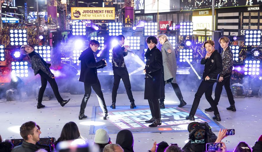 FILE - Members of BTS perform at the Times Square New Year's Eve celebration in New York on Dec. 31, 2019. The K-pop band is nominated for a Grammy Award for best pop duo/group performance with “Dynamite," their first song to hit the No. 1 spot on the Billboard Hot 100 chart. (Photo by Ben Hider/Invision/AP, File)