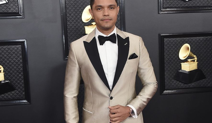 FILE - Trevor Noah arrives at the 62nd annual Grammy Awards in Los Angeles on Jan. 26, 2020. Noah has been tapped to host the 2021 Grammy Awards. The Recording Academy made the announcement hours before the nominees for the 2021 show would be revealed. It would mark Noah's first time hosting the Grammys. (Photo by Jordan Strauss/Invision/AP, File)